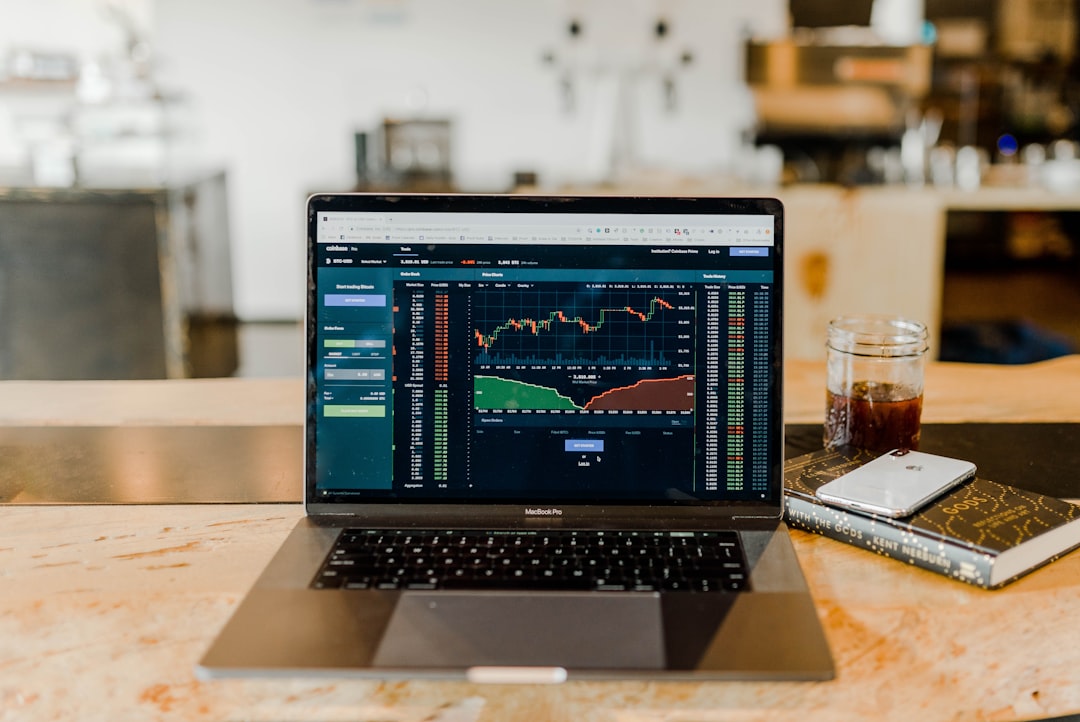 turned-on MacBook Pro with trading to illustrate funded account scaling plan
