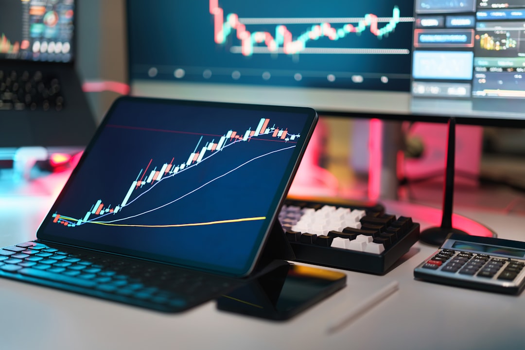 A laptop computer sitting on top of a desk to illustrate funded account scaling plan