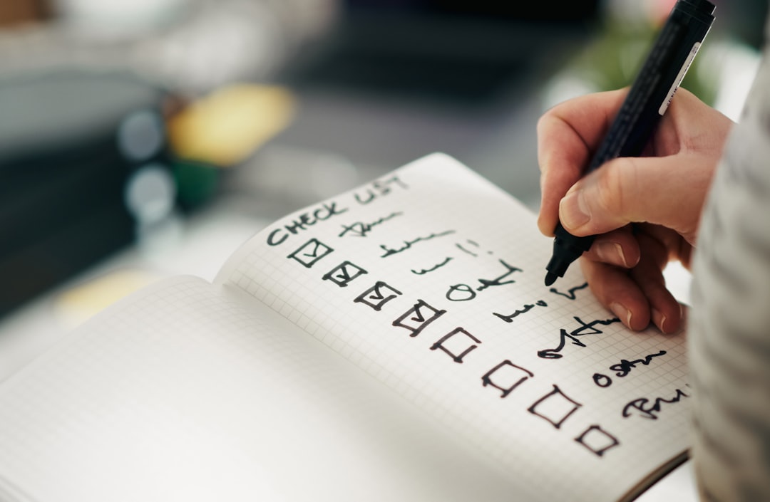 Someone is checking items off a checklist to illustrate how to choose an instant funded no evaluation account