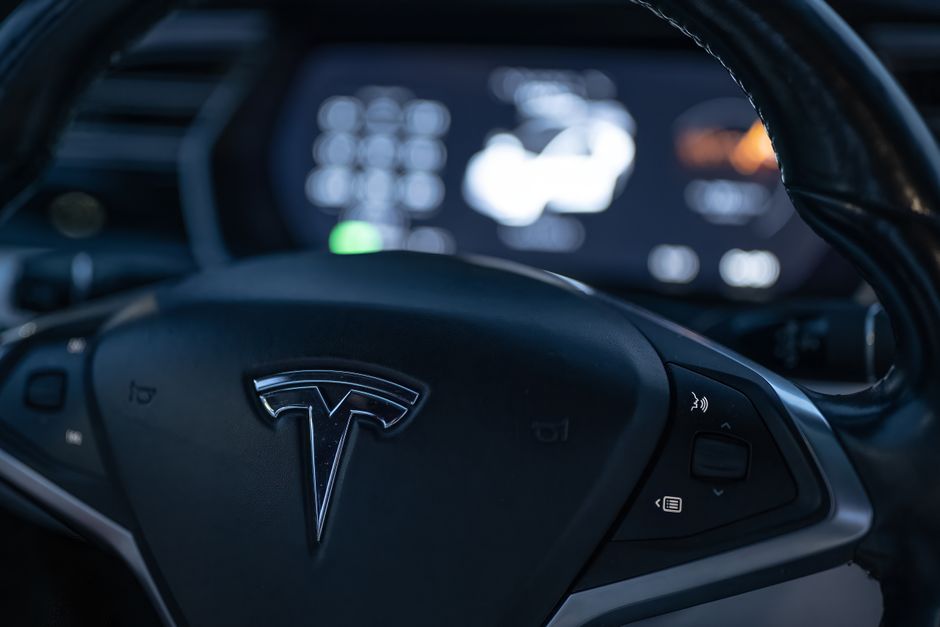 Tesla vehicle interior representing the real-world brand behind strategies to trade Tesla stock prop firm accounts.